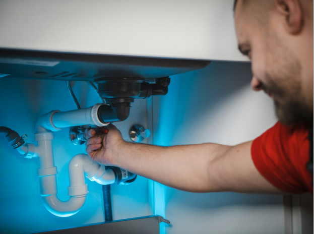 a plumber checking the drain