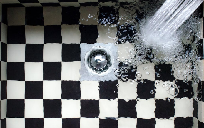 A sink in a Des Plaines home filled with standing water due to a clogged drain