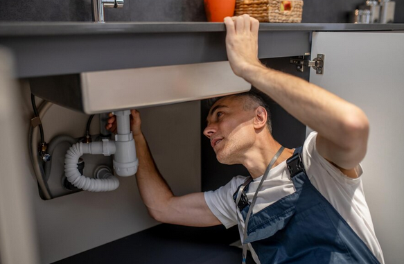 A plumbing technician arrives at an Aurora home for a late-night emergency call